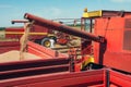 Combine harvester unloads wheat grain into the tractor trailer. Royalty Free Stock Photo