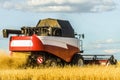 Combine harvester with ÃÂutter platform at work. Reaping machine.