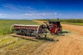 An old vintage combine harvester and a vintage tractor on the wheat fields at Sandsone Estates in South Africa