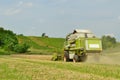 Combine harvester in wheat field during harvesting Royalty Free Stock Photo