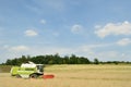 Combine harvester in wheat field during harvesting Royalty Free Stock Photo