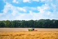 Combine harvester at work harvesting a field of wheat. Agricultural machinery theme. Royalty Free Stock Photo