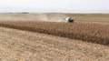 Combine harvester working in a corn field