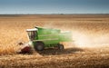 Combine harvester working in a corn field