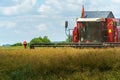 The combine harvester is working in the field. Agro-industrial complex, grain harvest season. Harvesting and harvesting of wheat, Royalty Free Stock Photo