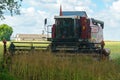 The combine harvester is working in the field. Agro-industrial complex, grain harvest season. Harvesting and harvesting of wheat, Royalty Free Stock Photo