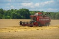 The combine harvester is working in the field. Agro-industrial complex, grain harvest season. Harvesting and harvesting of wheat, Royalty Free Stock Photo