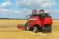 The combine harvester is working in the field. Agro-industrial complex, grain harvest season. Harvesting and harvesting of wheat, Royalty Free Stock Photo