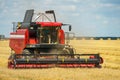 The combine harvester is working in the field. Agro-industrial complex, grain harvest season. Harvesting and harvesting of wheat, Royalty Free Stock Photo