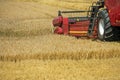 The combine harvester is working in the field. Agro-industrial complex, grain harvest season. Harvesting and harvesting of wheat, Royalty Free Stock Photo