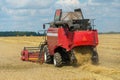 The combine harvester is working in the field. Agro-industrial complex, grain harvest season. Harvesting and harvesting of wheat, Royalty Free Stock Photo