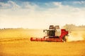 Combine harvester working on golden cereal field Royalty Free Stock Photo