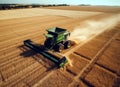 Combine harvester working on the large wheat crop field.