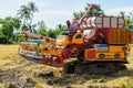 Combine harvester Working on rice field. Harvesting is the process of gathering a ripe crop from the fields Royalty Free Stock Photo