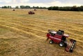 Combine harvester working in wheat field. Harvesting machine during cutting crop in a farmland. Combines during grain harvesting. Royalty Free Stock Photo