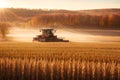 Combine harvester working on a wheat field at sunrise. Royalty Free Stock Photo