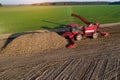 Combine harvesters harvest of sugar beet at summer evening