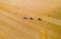 Combine harvesters reaping wheat top view from a drone