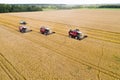 Combine harvesters reaping wheat top view from a drone