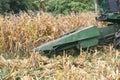 Combine harvesters are working in corn fields. Harvesting of corn field with combine in early autumn. Royalty Free Stock Photo