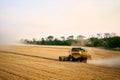 Combine harvesters working in a wheat field on sunset round about. Harvesting machine driver cutting crop in a farmland Royalty Free Stock Photo