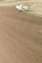 Combine harvesting a fall corn field Royalty Free Stock Photo