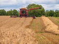 Combine harvesting wheat in the field.