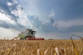 Combine harvesting a wheat field. Combine working the field. Royalty Free Stock Photo