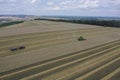 The combine harvests ripe golden wheat in the grain field. Agricultural work in summer. Drone recording. ÃÅ¡ri, Hungary - 22/07/