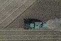 The combine harvests ripe wheat in the grain field. Agriculture. Aerial view. From above.