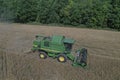 The combine harvests ripe wheat in the grain field. Agriculture. Aerial view. From above.