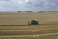 The combine harvests ripe wheat in the grain field. Agriculture. Aerial view. From above.