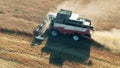 Combine is reaping wheat along the field