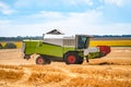 combine working on the large wheat field harvesting yellow ripe wheat. Agricultural concept Royalty Free Stock Photo