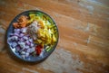 Combined indian spices and ingredients for making curry in a steel plate with wooden background