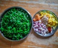 Combined indian spices and ingredients for making spinach curry ( indian cuisine ) with wooden background