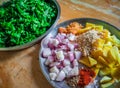 Combined indian spices and ingredients for making spinach curry ( indian cuisine ) with wooden background