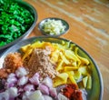 Combined indian spices and ingredients for making spinach curry ( indian cuisine ) with wooden background