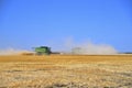 Combines Harvesting in a Wheat Field Royalty Free Stock Photo