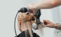 Combing the hair drying brush. Stylist drying woman hair in hairdresser salon Royalty Free Stock Photo