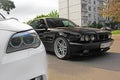 Kharkov, Ukraine. Autumn, September, 2017; Combo BMW. Two BMW M5 - black and white. BMW M5 F10 and M5 E34 in the city Royalty Free Stock Photo