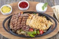 Combo Fajita; top down photo of mexican steak and chicken fajitas in iron skillet with corn tortillas Royalty Free Stock Photo