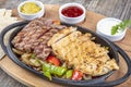 Combo Fajita; top down photo of mexican steak and chicken fajitas in iron skillet with corn tortillas Royalty Free Stock Photo