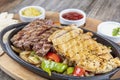 Combo Fajita; top down photo of mexican steak and chicken fajitas in iron skillet with corn tortillas Royalty Free Stock Photo