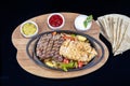 Combo Fajita; top down photo of mexican steak and chicken fajitas in iron skillet with corn tortillas Royalty Free Stock Photo