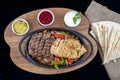 Combo Fajita; top down photo of mexican steak and chicken fajitas in iron skillet with corn tortillas Royalty Free Stock Photo