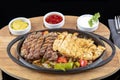 Combo Fajita; top down photo of mexican steak and chicken fajitas in iron skillet with corn tortillas Royalty Free Stock Photo