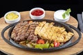 Combo Fajita; top down photo of mexican steak and chicken fajitas in iron skillet with corn tortillas Royalty Free Stock Photo