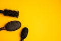 Combs and hairdresser tools in beauty salon work desk on yellow background top view space for text Royalty Free Stock Photo