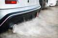 combustion fumes coming out of car exhaust pipe Royalty Free Stock Photo